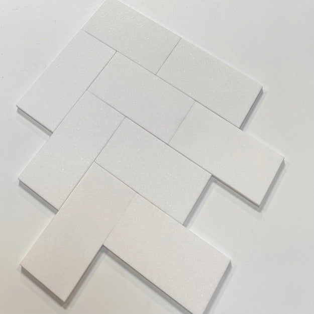 White Thassos marble subway tiles with a polished 3x6 format, arranged for a modern backsplash or wall installation.