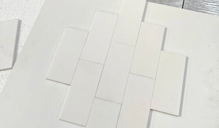 Pristine White Thassos subway tiles showcasing their luxurious white tone and glossy finish, ideal for bathrooms or kitchen accents.