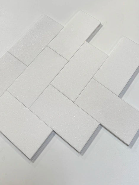 Elegant 3x6 White Thassos marble tiles arranged in a classic subway pattern, perfect for upscale interior design projects.