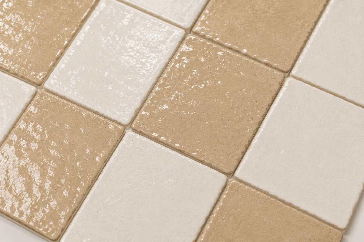 Close-up of Adeline glossy Zellige checkerboard showing handmade glaze and edge variation, Sand & Ivory.
