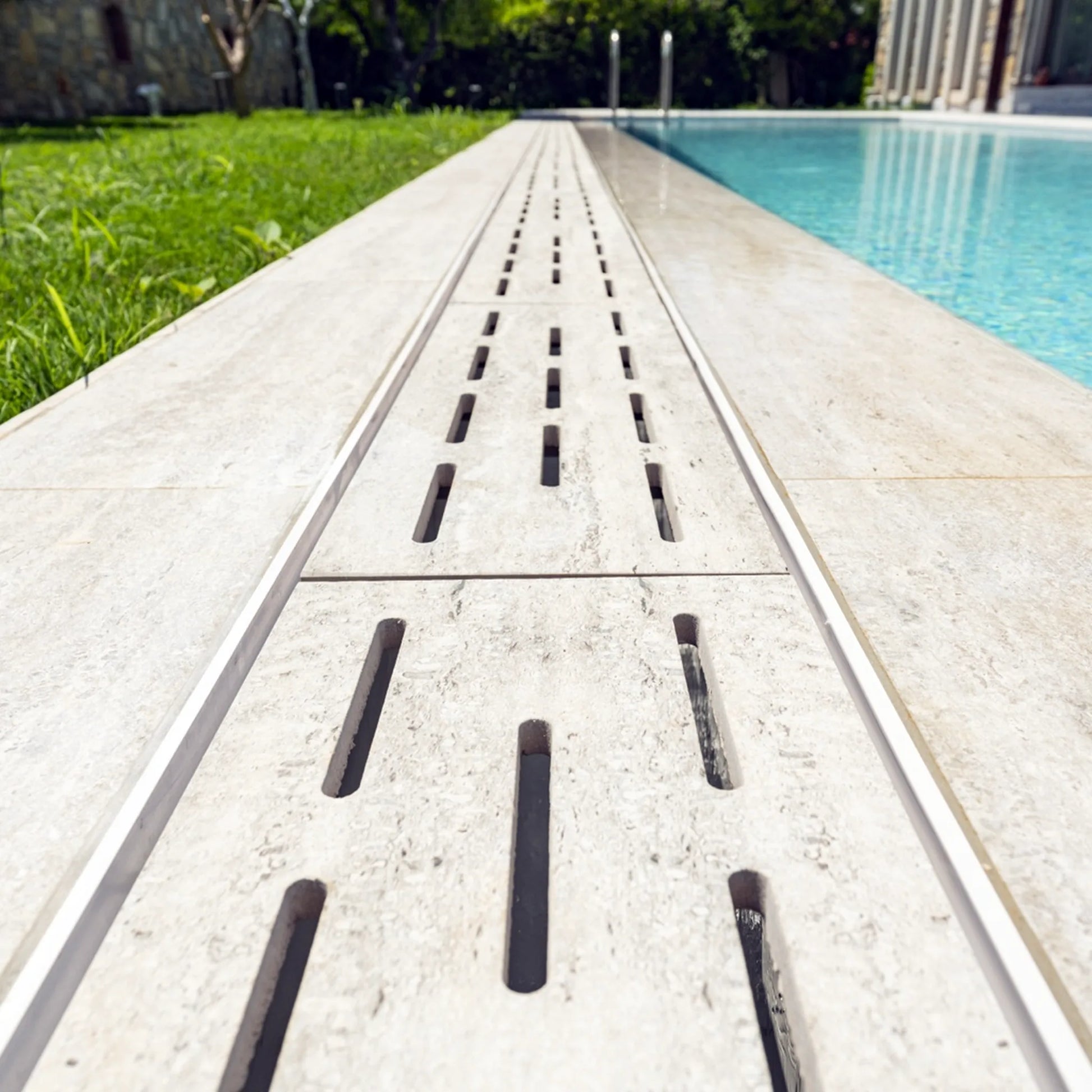 SeraPool Relax porcelain flexible drain grate installed as long linear run along poolside