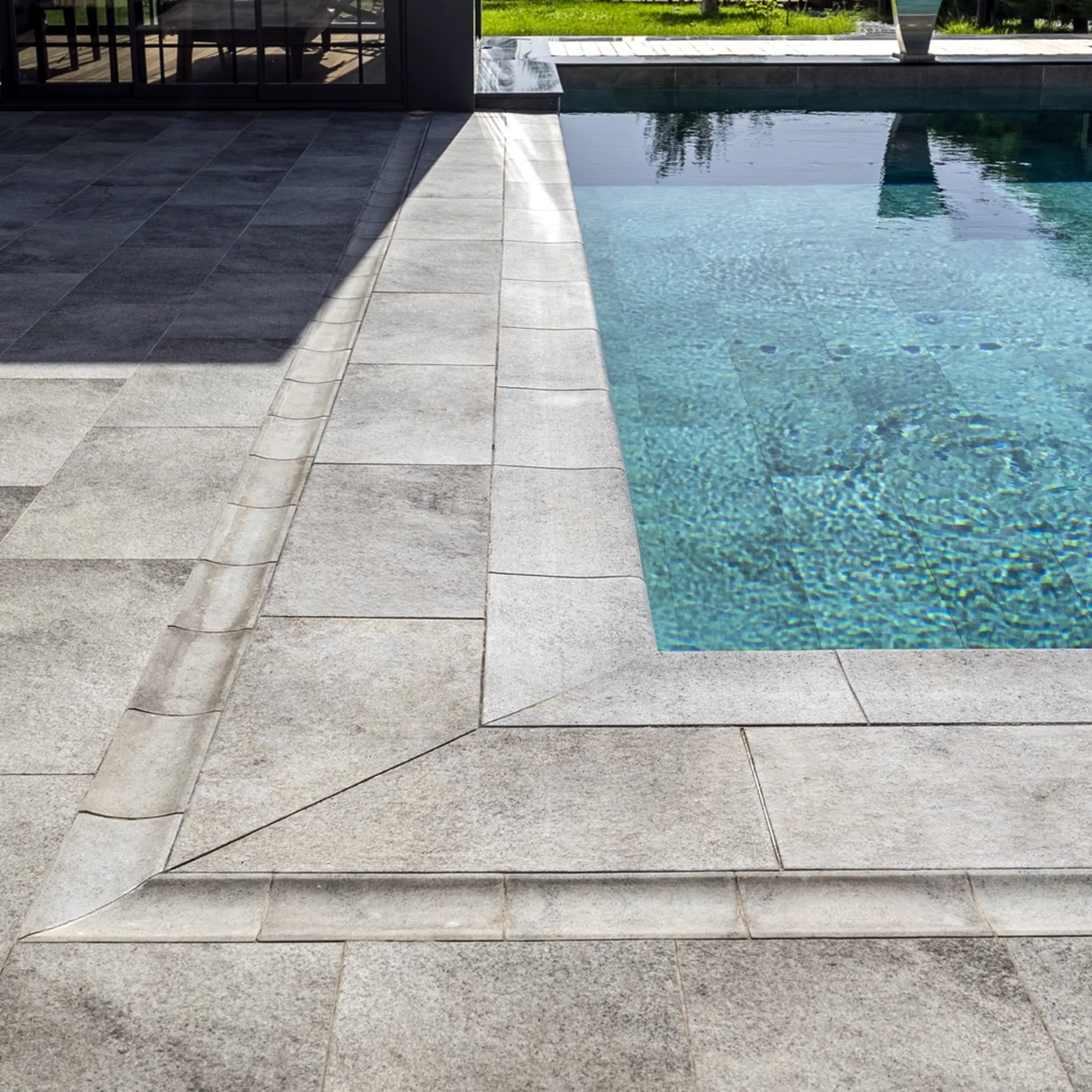 SeraPool Installed pool coping detail with porcelain deck pavers and turquoise pool water, Relax Pool & Spa collection