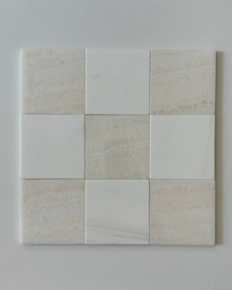 A custom-cut checkerboard tile layout mixing White Onyx and Bianco Dolomite tiles, providing a sleek, polished look for any interior. The luxurious combination of white tones offers a fresh and modern appeal.