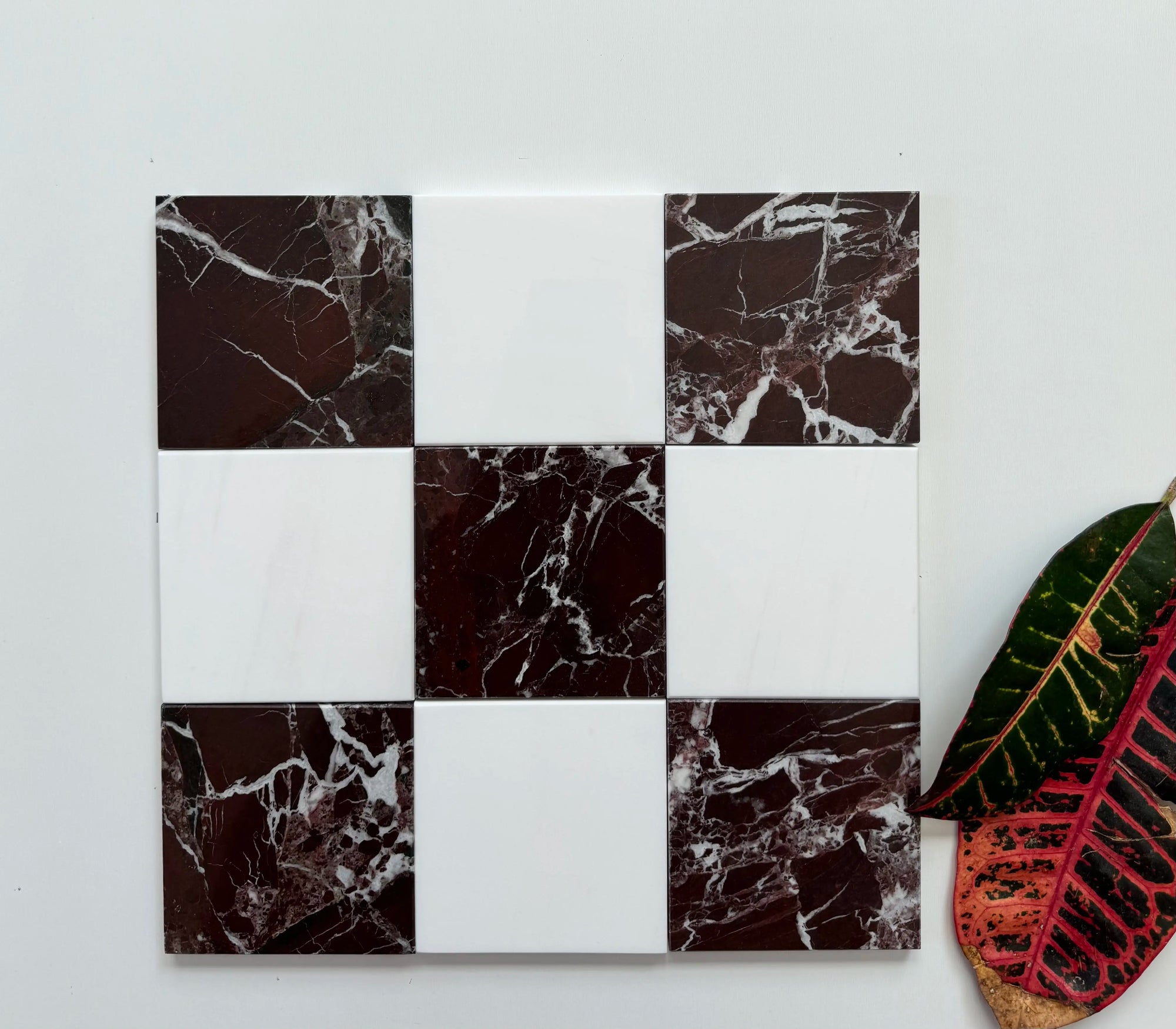 Elegant marble checkerboard pattern with deep red Rosso Levanto marble tiles and classic white Bianco Dolomite marble tiles. The dynamic color combination creates a timeless aesthetic perfect for upscale interiors or statement flooring.