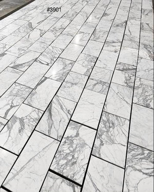 Statuary White marble 12×24 tile natural white and gray veining close-up.