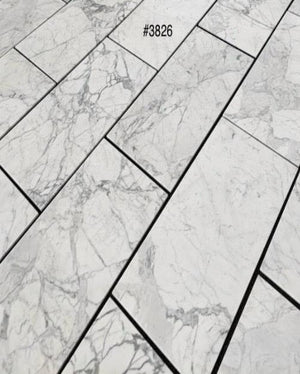 Statuary White marble 18×36 tile natural white and gray veining close-up.
