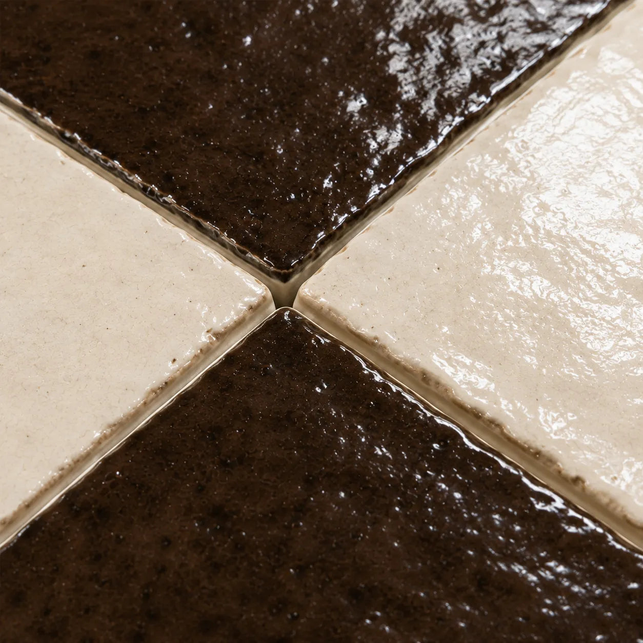 Close-up of Lucienne glossy Zellige checkerboard showing handmade glaze and edge variation, Espresso & Ivory.