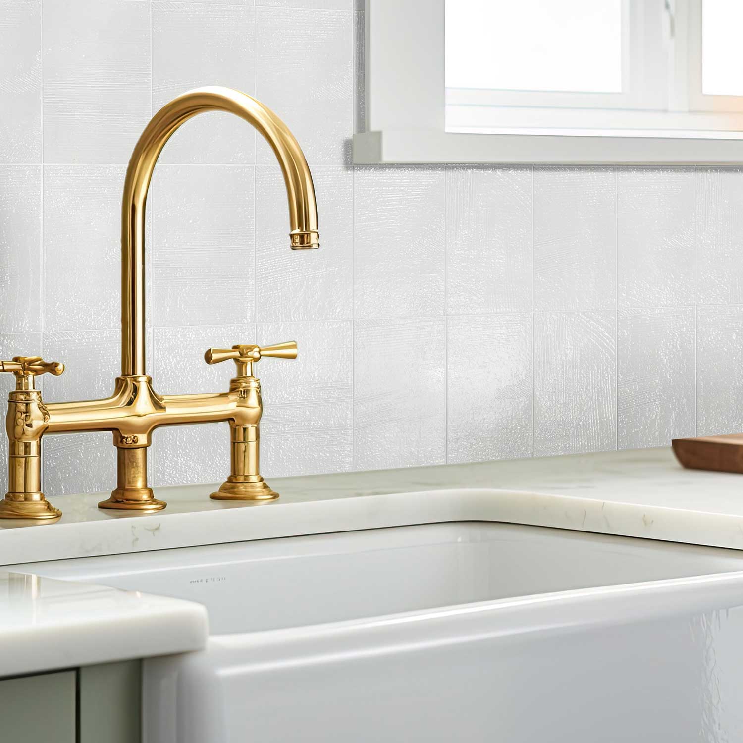 Kitchen backsplash with Luna Plaster textured porcelain tiles and brass faucet – Stria Collection.
