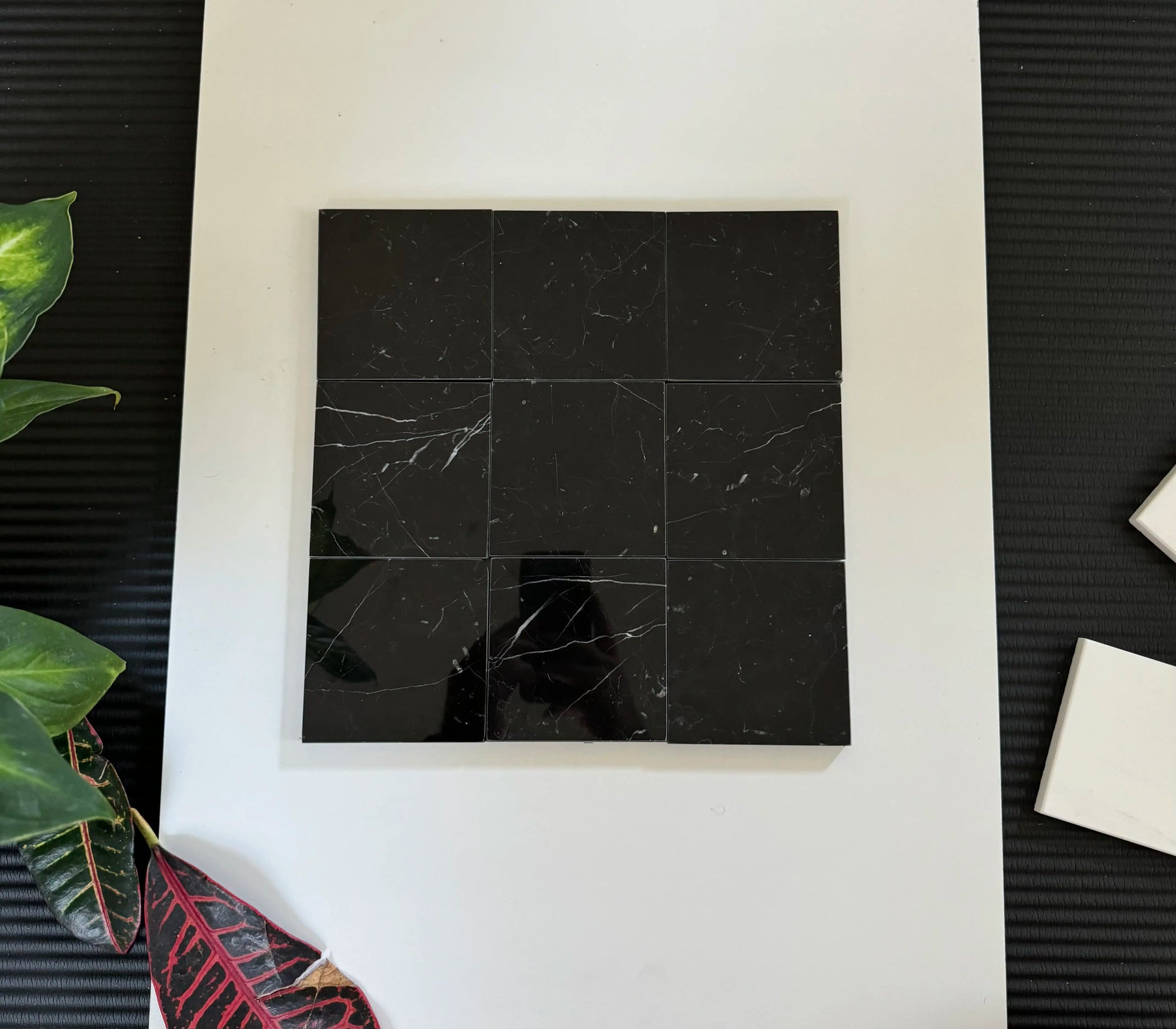 A sophisticated arrangement of Nero Marquina marble tiles forming a checkerboard pattern.