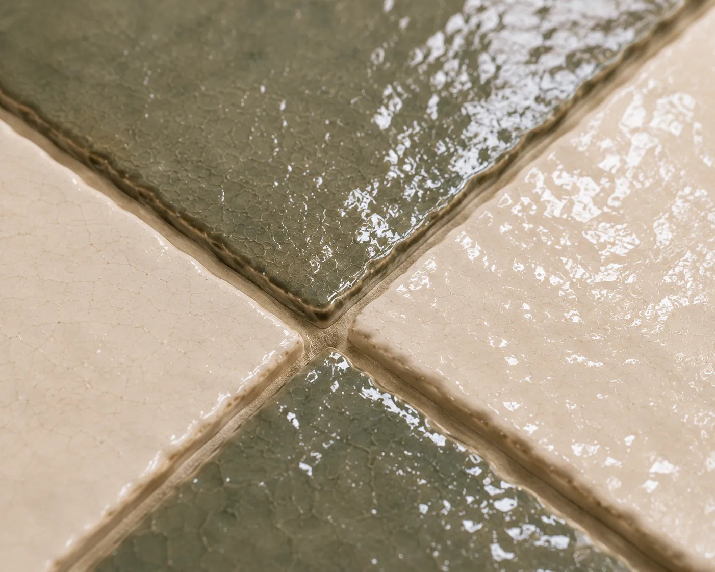 Close-up of Noémie glossy Zellige checkerboard showing handmade glaze and edge variation, Soft Sand & Ivory.