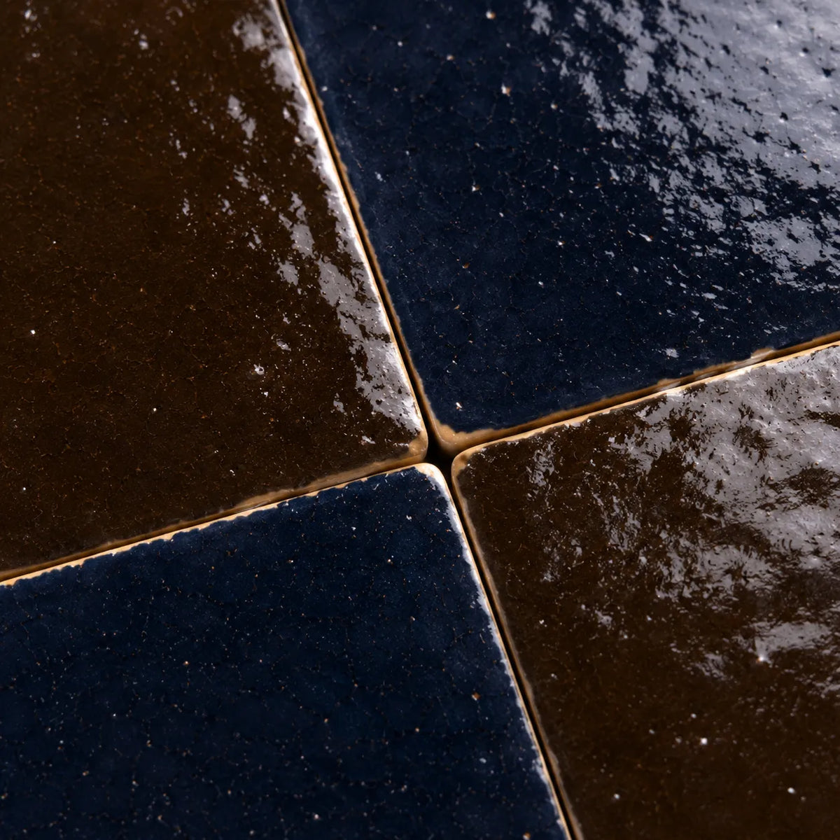 Close-up of Odette glossy Zellige checkerboard showing handmade glaze and edge variation, Indigo & Cacao.