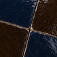 Macro detail of Odette Checkerboard Zellige Tile showing Indigo Bazaar and Noir Cacao glaze movement, texture, and handcrafted Moroccan Zellige character.