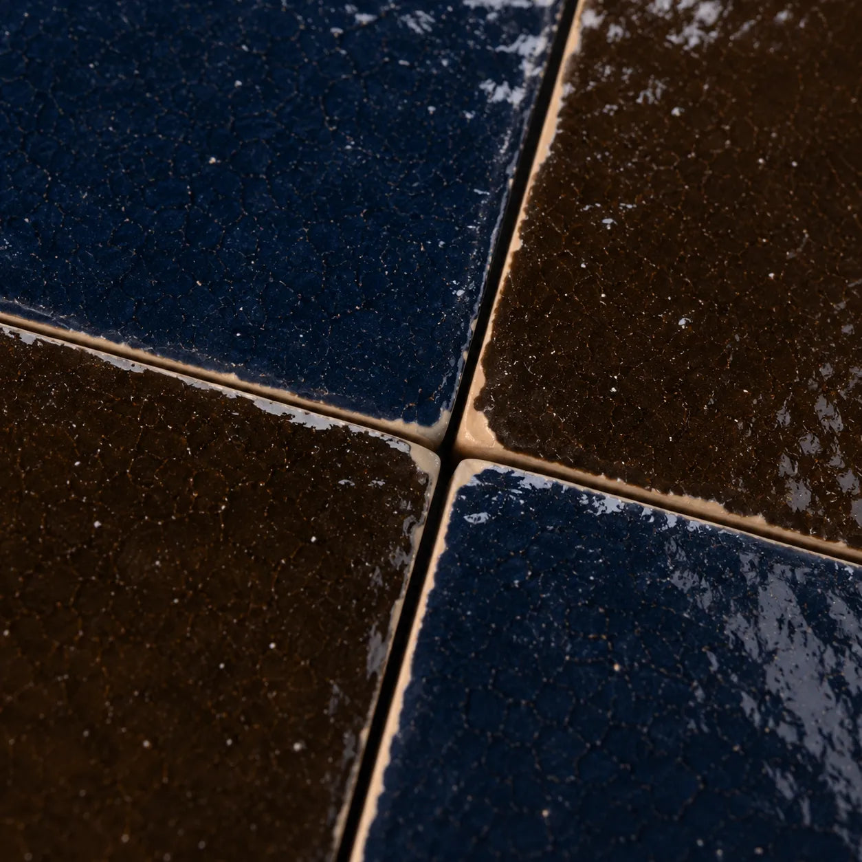 Close-up of Odette glossy Zellige checkerboard showing handmade glaze and edge variation, Indigo & Cacao.