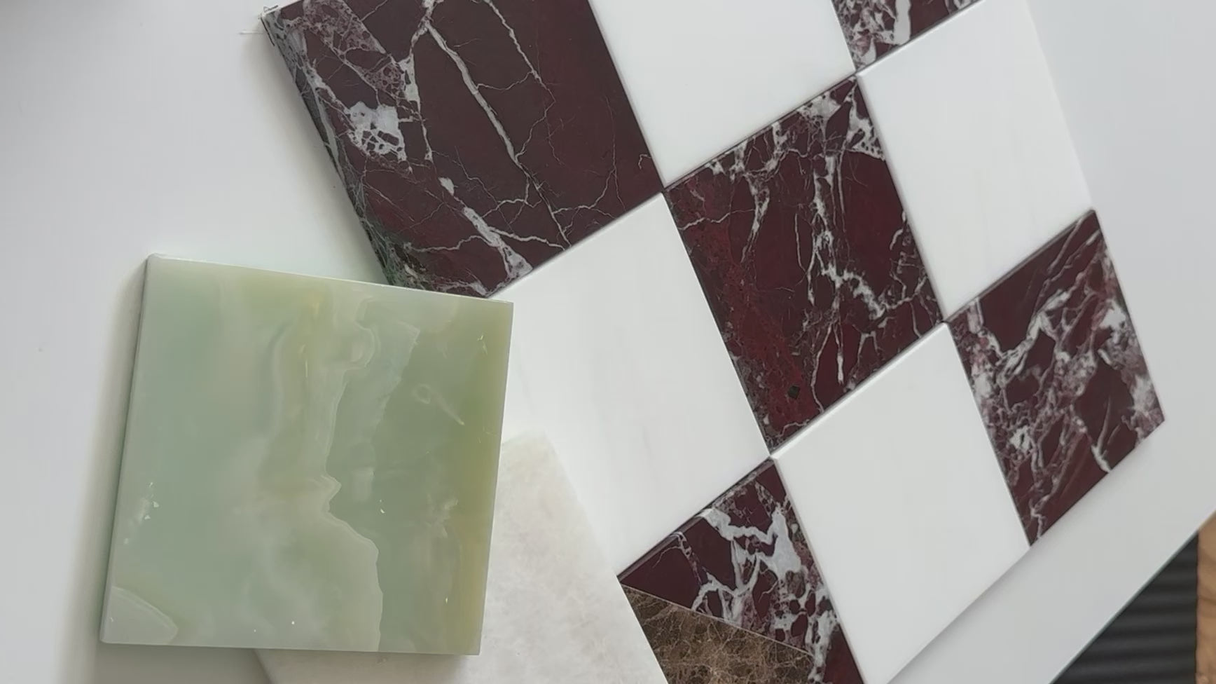 Load video: A sophisticated checkerboard design using Rosso Levanto Italian red marble paired with Bianco Dolomite marble tiles. The blend of bold red marble with subtle white tones adds richness to kitchens, bathrooms, or hallways.