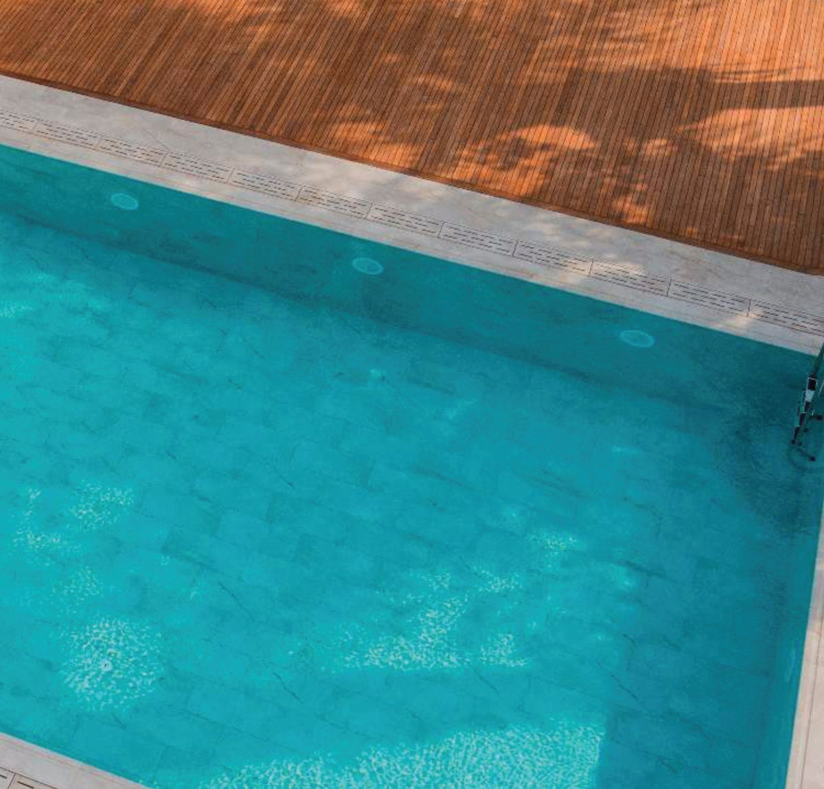 Beige Stone porcelain pool deck and coping at the pool edge