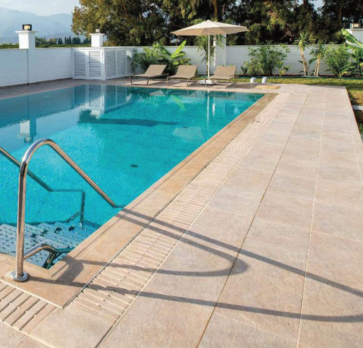 Natural Mocha porcelain pool deck and coping at the pool edge