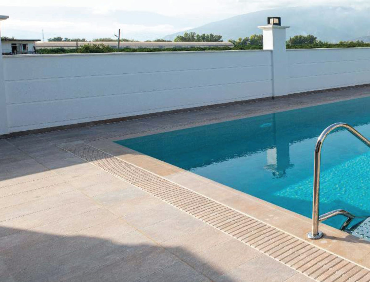 Natural Mocha porcelain pool deck tile around a residential pool, project example