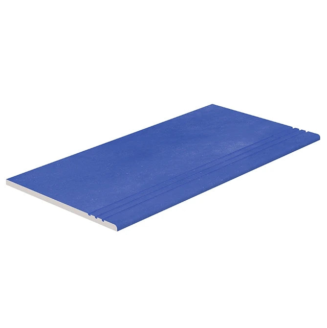 A blue textured rectangular Serapool relax pastel cobalt color porcelain anti-slip stair tile shown at an angle on a plain white background.