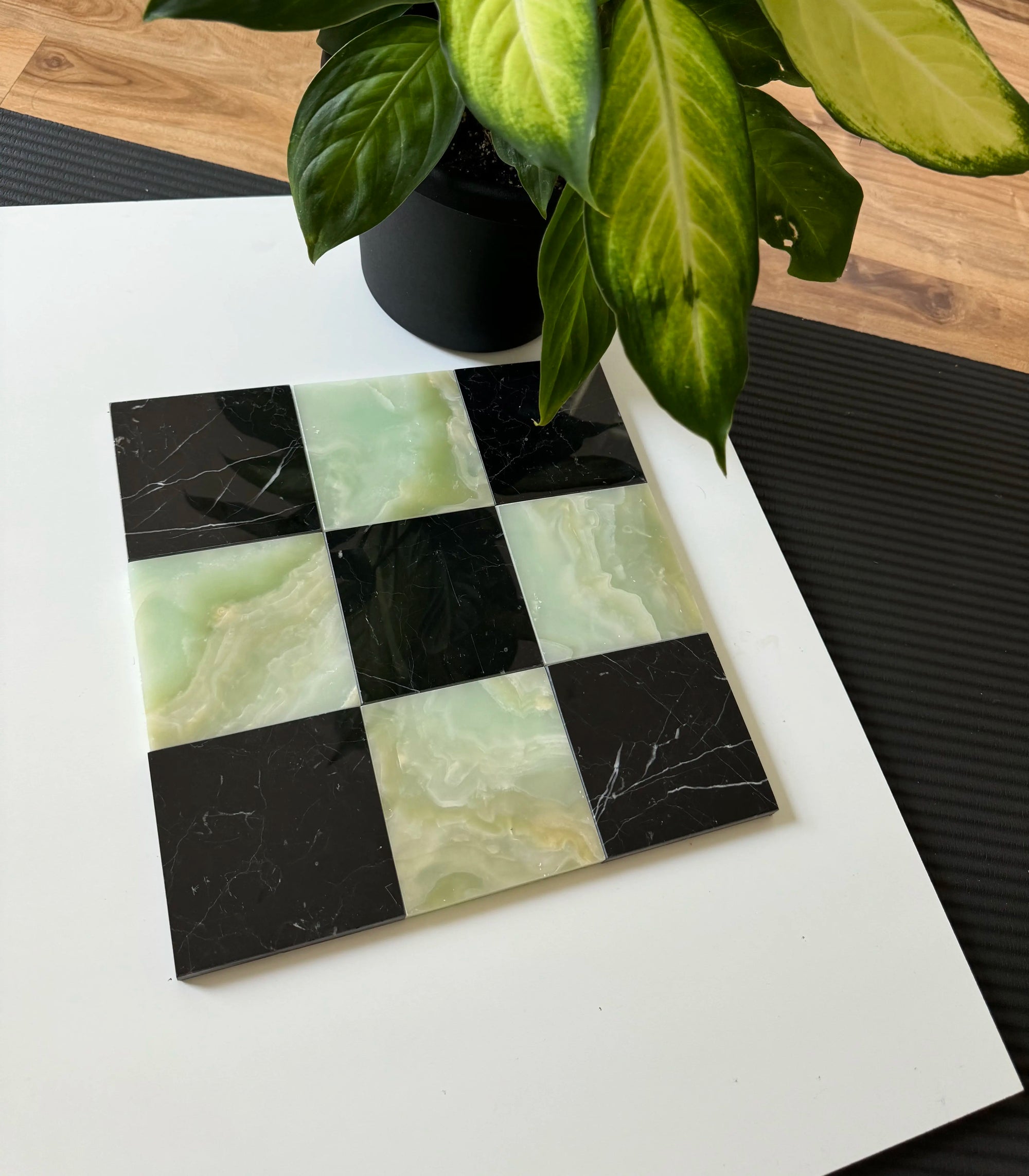 A sophisticated arrangement of Green Onyx and Nero Marquina marble tiles forming a checkerboard pattern. The rich green onyx contrasts beautifully with the sleek black marble, making it perfect for statement flooring or accent walls.
