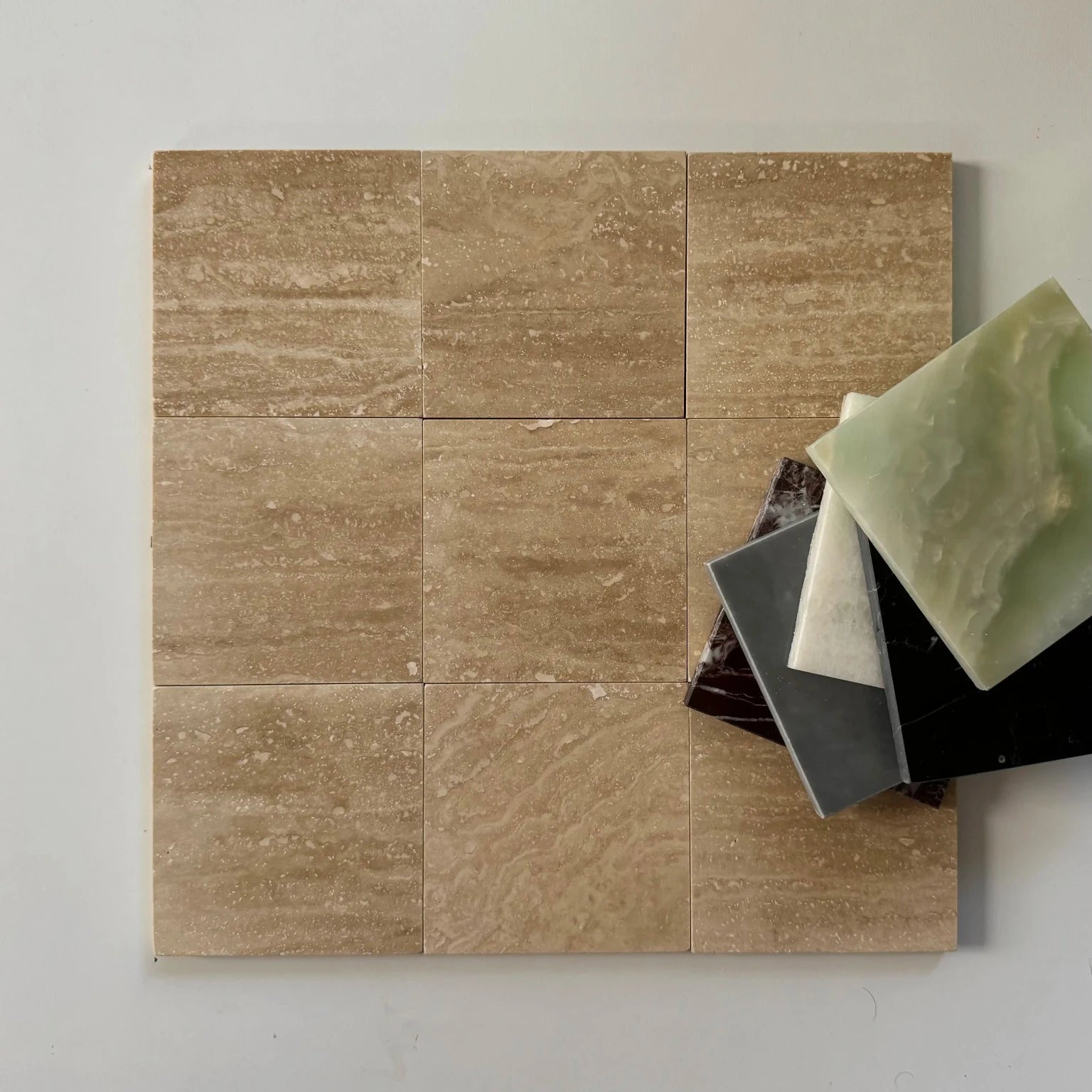 A checkerboard tile arrangement featuring classic vein-cut Roman Travertine tiles alongside the rich red tones of Rojo Alicante marble. The mix of beige travertine and red marble creates a timeless design for upscale flooring or wall applications