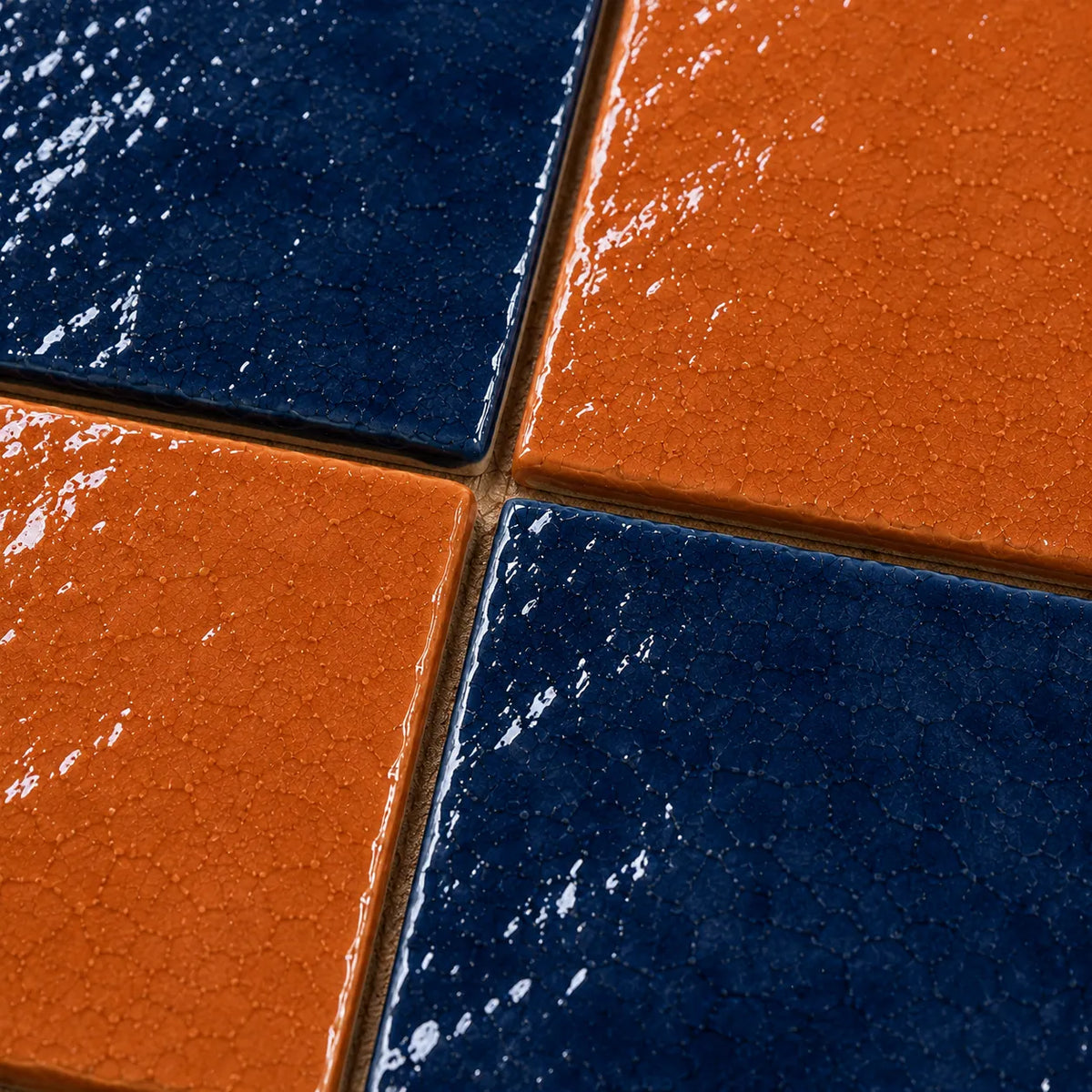 Close-up of Vivienne glossy Zellige checkerboard showing handmade glaze and edge variation, Indigo & Terracotta.