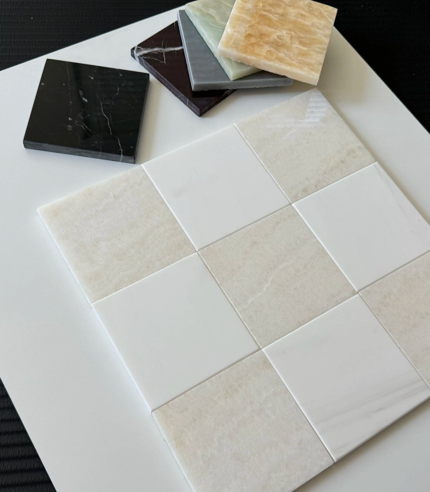 White Onyx and Bianco Dolomite tiles displayed in a sleek checkerboard design. The creamy tones and white contrasts create an elegant and modern look for high-end tiling projects.