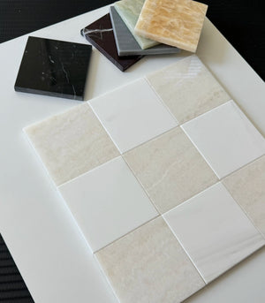 White Onyx and Bianco Dolomite tiles displayed in a sleek checkerboard design. The creamy tones and white contrasts create an elegant and modern look for high-end tiling projects.